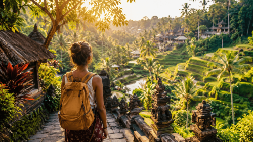 A solo traveler exploring the lush landscapes of Ubud, walking through tropical rice terraces and jungle paths, capturing the peaceful and cultural experience of Bali tours designed for solo travelers.