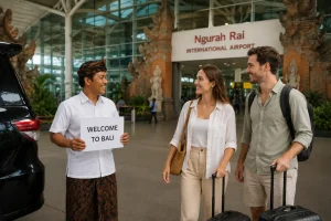 Friendly airport pickup guide welcoming international travelers at Bali Airport with private transfer service.