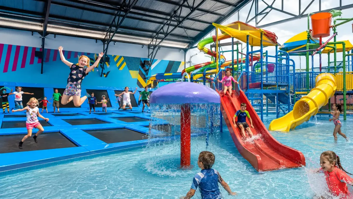 Children enjoying the trampoline park and swimming pool at Finns Recreation Club in Canggu, Bali.