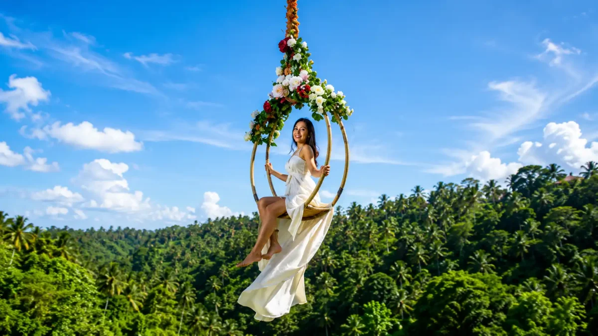 A traveler enjoying the iconic jungle Bali swing Ubud at Aloha Ubud Swing, soaring above lush rice terraces, tropical palm trees, and beautifully landscaped gardens while experiencing one of Ubud’s most popular photo spots.