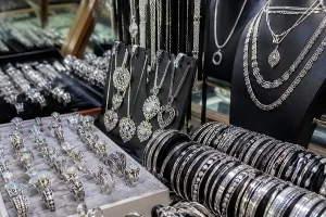 A close-up display of finely detailed, custom handmade silver jewelry created during a professional art workshop bali. | balitouristic.com