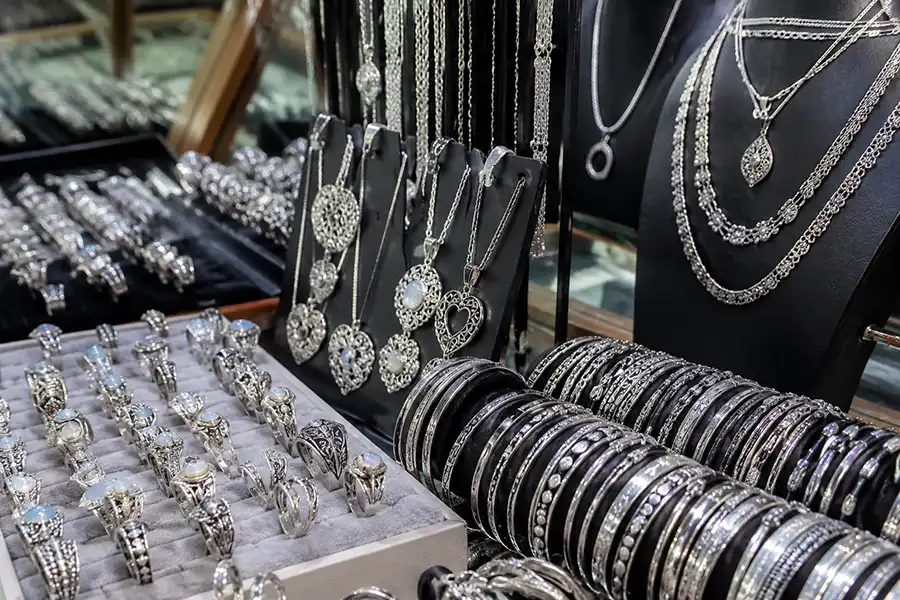 A close-up display of finely detailed, custom handmade silver jewelry created during a professional art workshop bali. | balitouristic.com