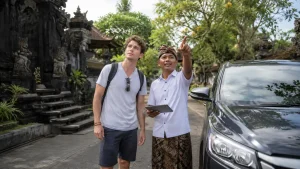 Travelers exploring the lush rice fields of Bali, walking through scenic green terraces, learning about traditional farming practices, and enjoying the peaceful countryside atmosphere surrounded by tropical landscapes.