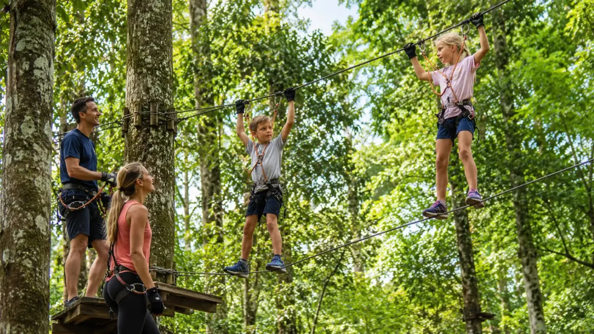 Children enjoying a high ropes course at Bali Treetop Adventure Park in Bedugul.