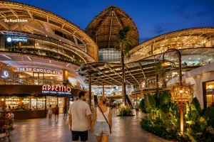 A modern shopping mall Bali experience at ICON Bali featuring contemporary architecture, stylish retail stores, open-air spaces, tropical landscaping, and visitors enjoying a vibrant lifestyle and shopping destination near Bali’s coastline.