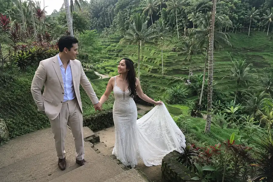 An elegant couple holding hands during a pre-wedding photo session at Tegalalang Rice Terraces, one of the most interesting places in bali. | balitouristic.com
