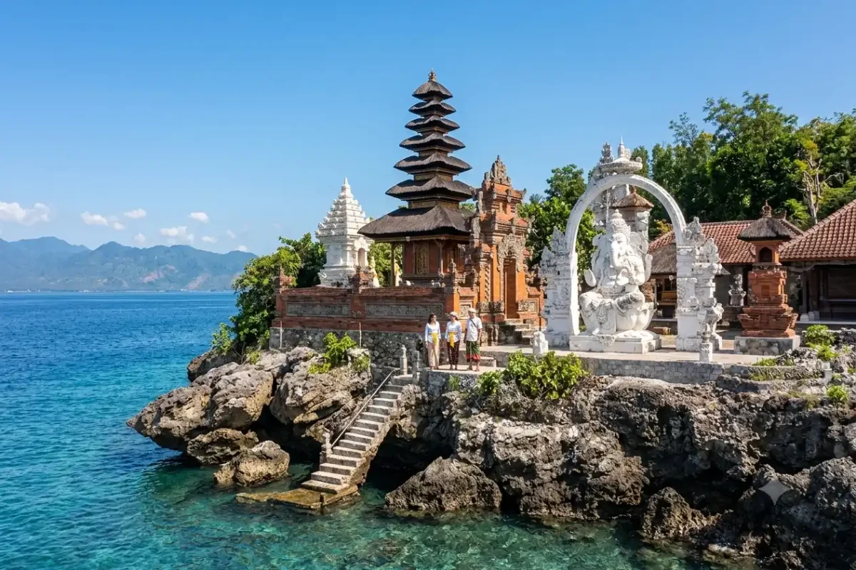 A serene view of the temple on Menjangan Island featuring traditional Balinese architecture, stone shrines overlooking crystal-clear turquoise waters, lush tropical surroundings, and a peaceful spiritual atmosphere set within the island’s pristine natural landscape.