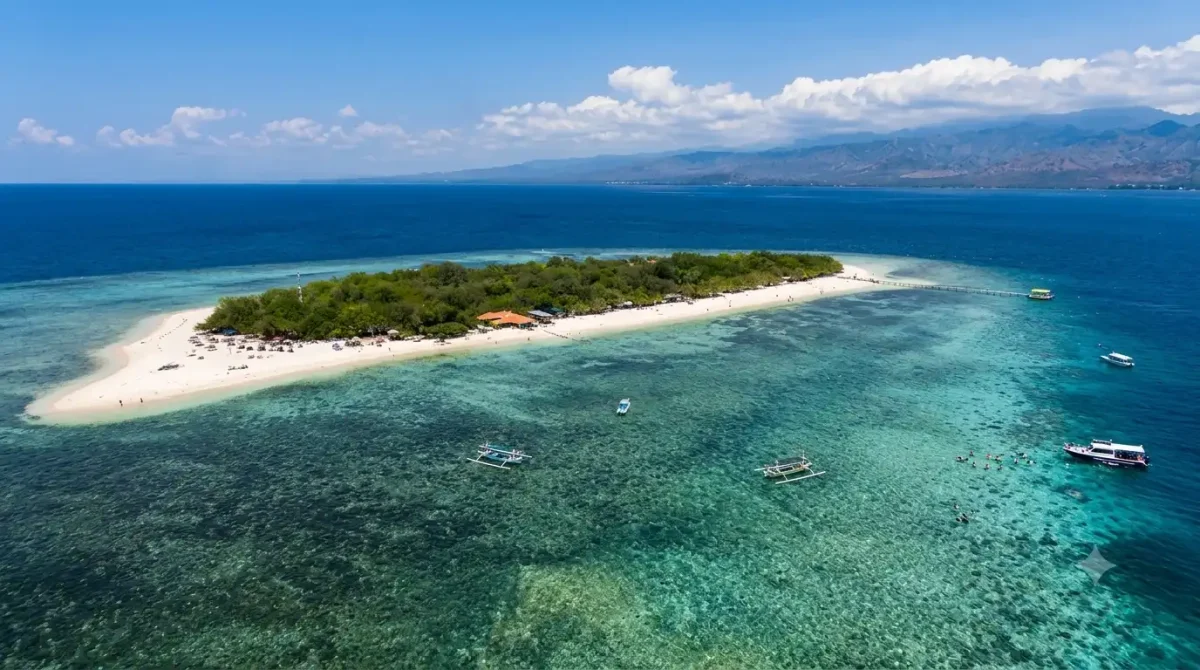 A breathtaking view of Menjangan Island featuring crystal-clear turquoise waters, white sandy beaches, vibrant coral reefs, and lush tropical forests, showcasing one of Bali’s most beautiful snorkeling and diving destinations.