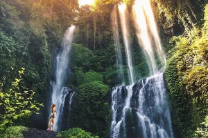 Woman admiring the breathtaking beauty of Sekumpul Waterfall in North Bali.