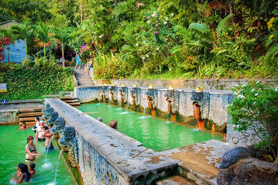Visitors relaxing in the natural thermal pools at Banjar Hot Springs in North Bali.