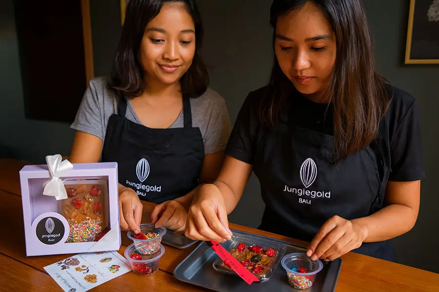 Visitors enjoying an interactive chocolate factory experience in Bali.