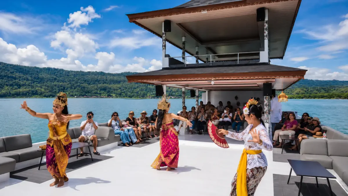 Tourists enjoying an adventure Bali peaceful boat cruise on Lake Batur surrounded by volcanic mountain scenery.