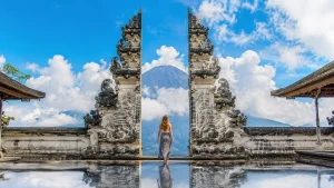 Woman posing at Lempuyang Gate of Heaven with Mount Agung in the background.