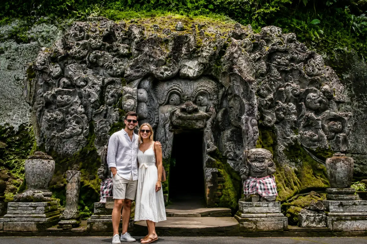 Couple exploring the historic Goa Gajah Temple in Ubud as one of top tourist attractions in Bali.
