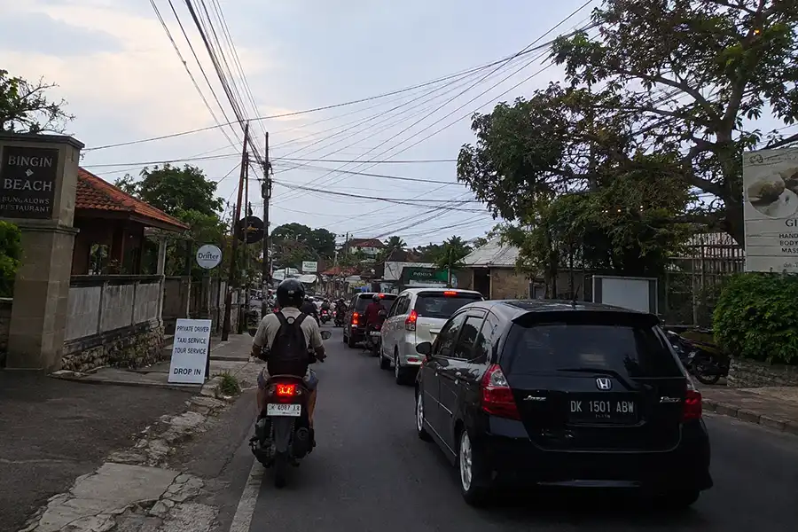 A traveler riding a scooter along the road from Bingin to Uluwatu.