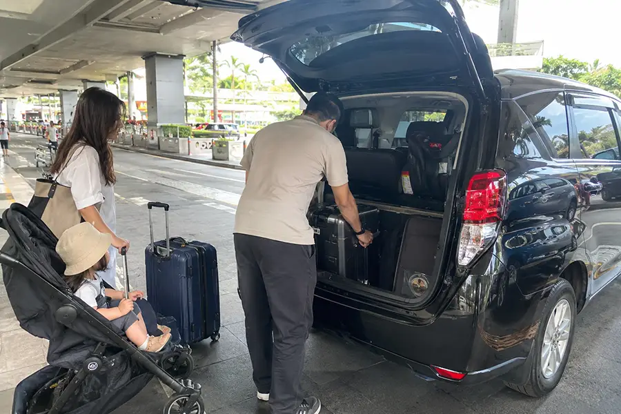 Family preparing for a Bali airport transfer with a child seat