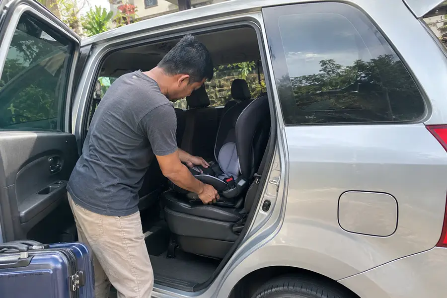 Child seat prepared inside a Bali family transfer vehicle