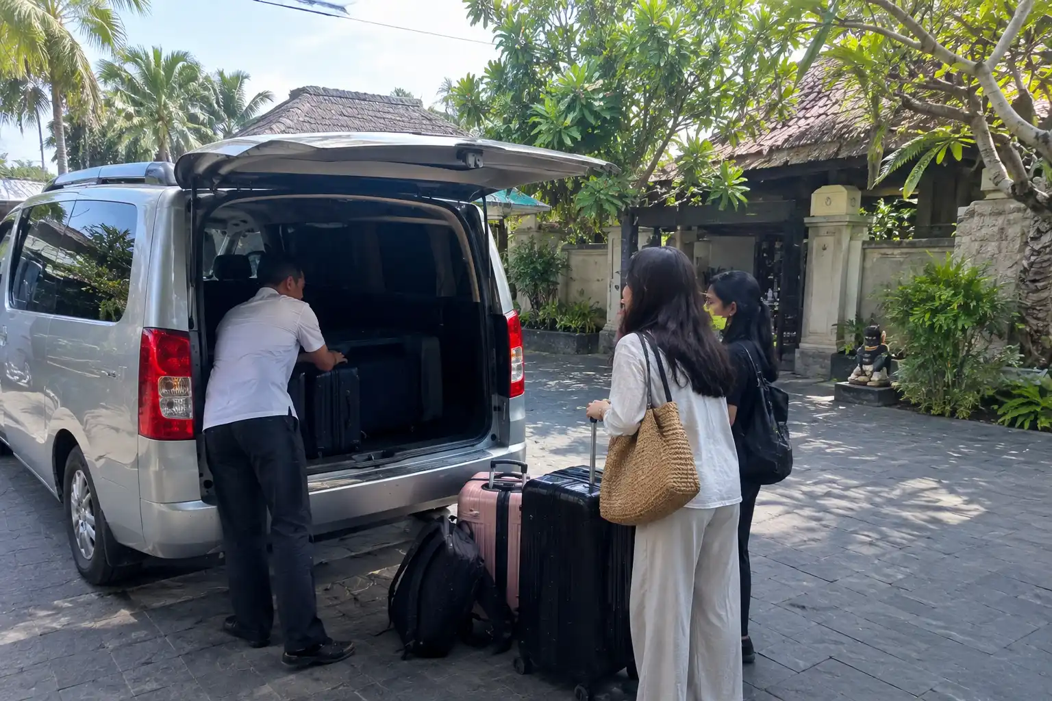 Driver helping passengers with luggage in Bali