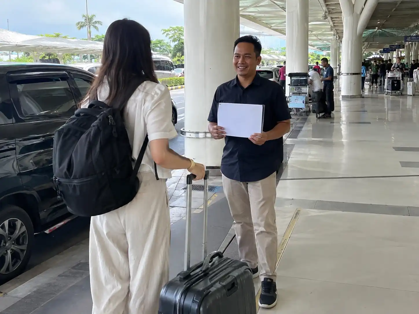 Driver meeting traveller at Bali Airport pickup area