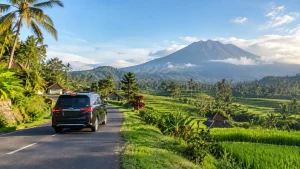 Car driving past Mount Agung on a Bali airport to Sidemen transfer.