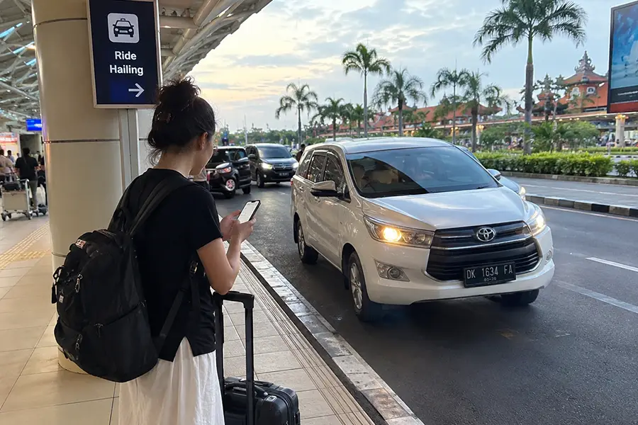 Traveller arranging a ride-hailing pickup in Bali