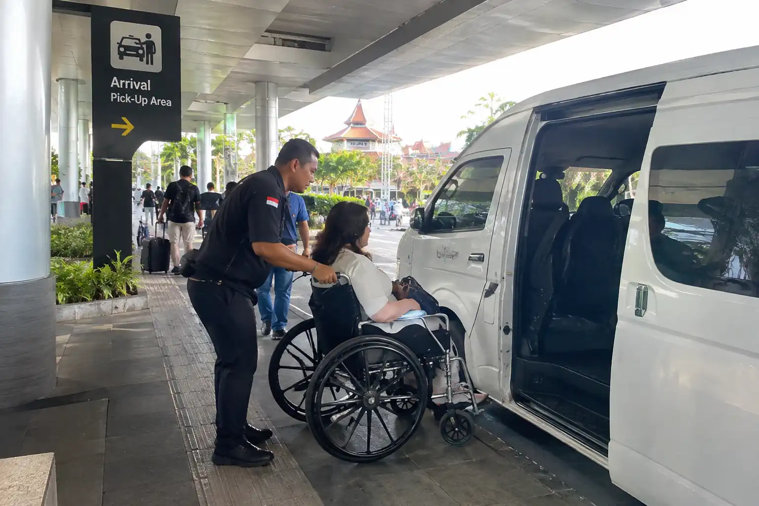 Wheelchair passenger meeting an airport transfer driver at Bali Airport