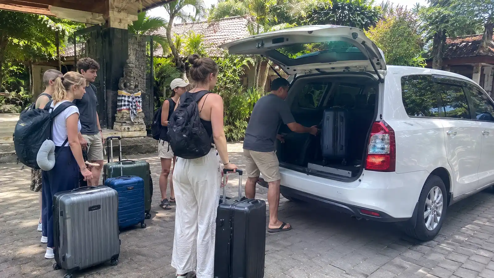 Large group with luggage preparing for a Bali private driver trip