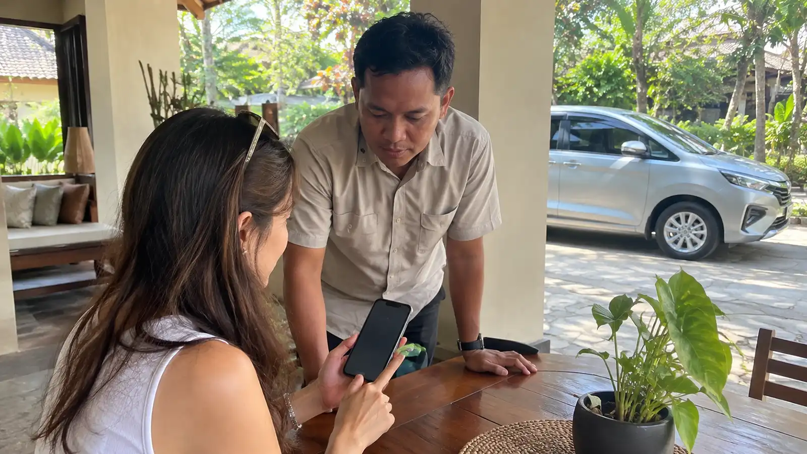 Traveller confirming Bali private driver booking details with a driver