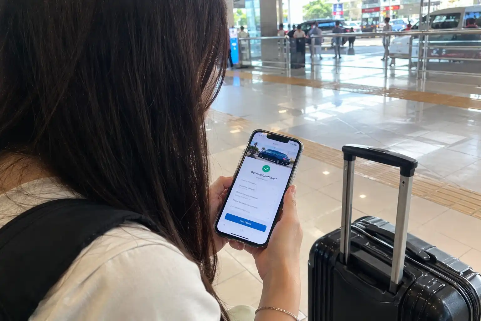 Traveller checking Bali airport transfer booking confirmation