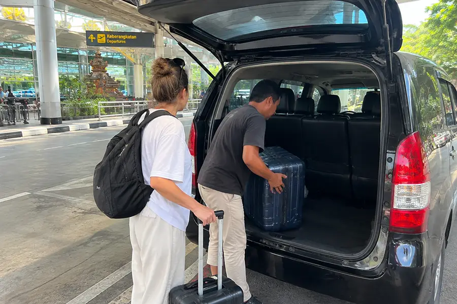 Private transfer driver helping with luggage at Bali Airport