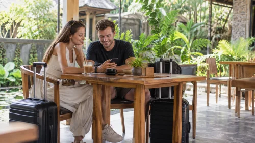 A couple enjoying coffee with suitcases