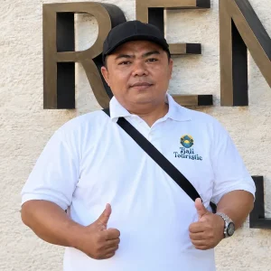 Agus Kupit, Bali Touristic driver giving two thumbs up in a branded white polo shirt