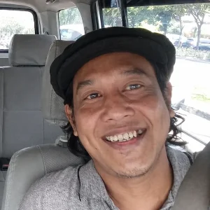 Ferry, Bali Touristic airport transfer driver, smiling inside the transfer van