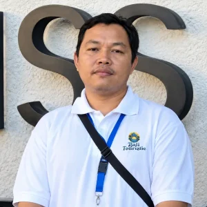 Hary, Bali Touristic airport driver with a staff ID lanyard, ready to meet guests at DPS